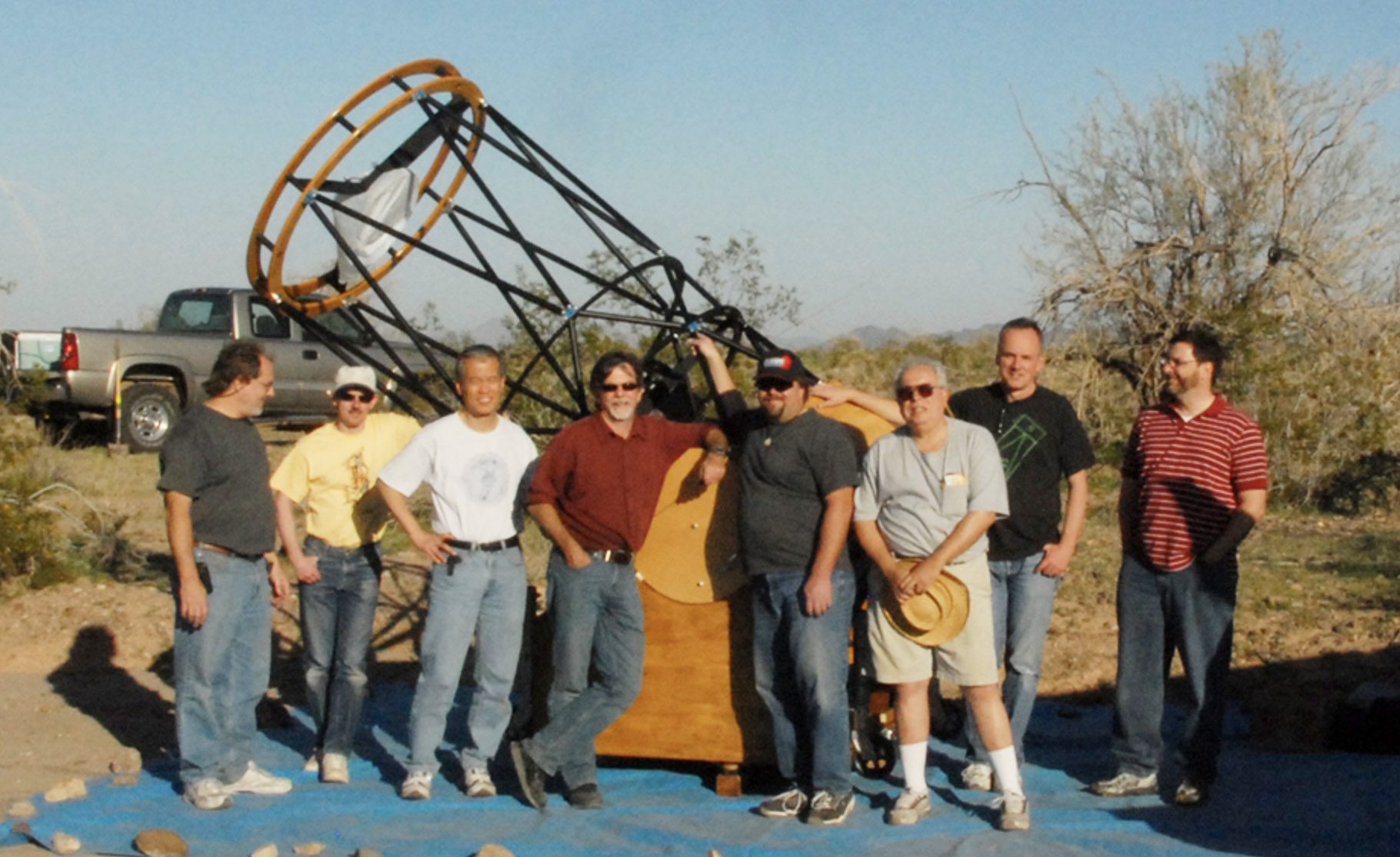 Team standing in front of telescope - first light